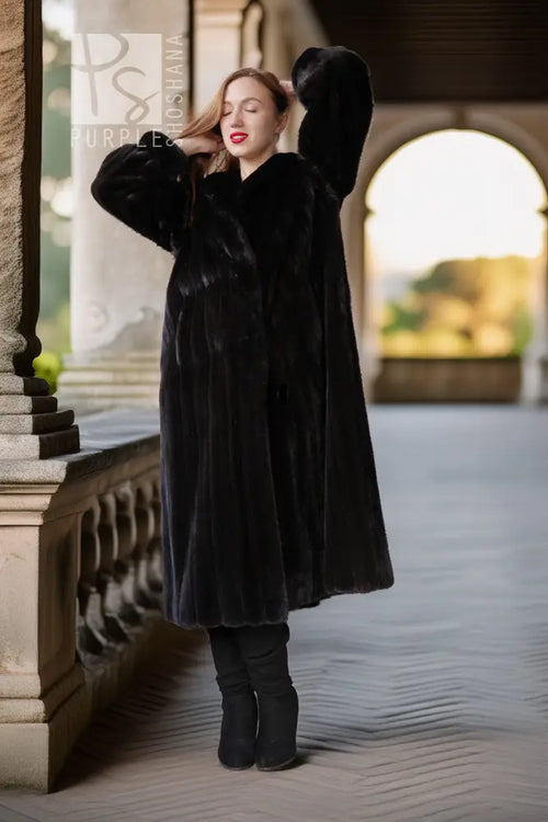 Long dark mink coat with wide sleeves and button front, standing full view