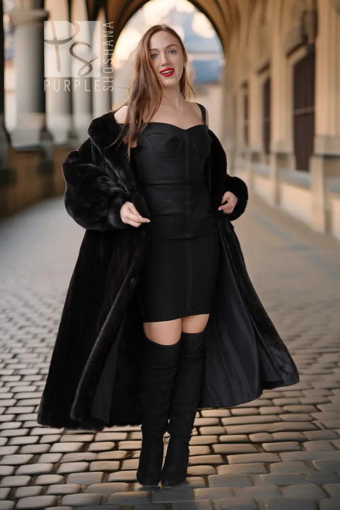 Black fur coat with button-front, off-shoulder neckline, long sleeves, front view.