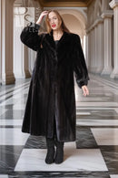 Black long fur coat with button front and raised collar, full-body view