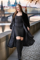 Black fur coat with button-front, wide skirt hem, long sleeves, standing pose.