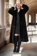 Black fur coat with button front and wide collar, long sleeves, knee length
