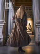 Back view of full-length mink fur coat with fox-trim collar and flowing skirt hem