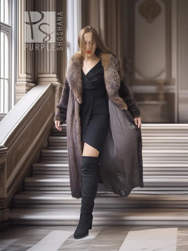 Full-length mink fur coat worn over a black dress; fox-trimmed collar and open front