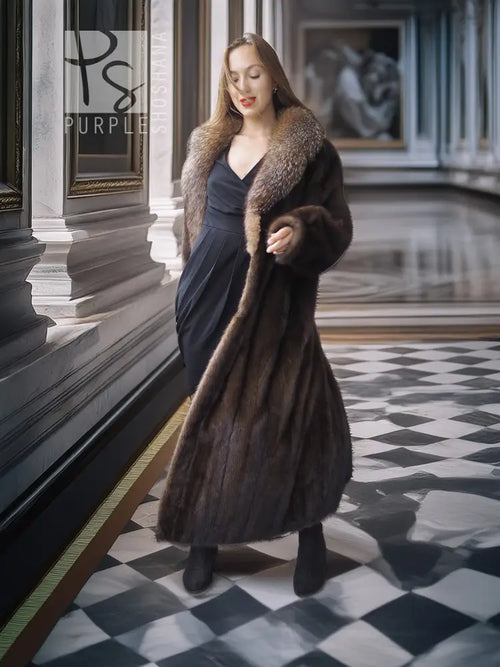 Full-length mink coat with dark fur trim, long sleeves, belted wrap silhouette