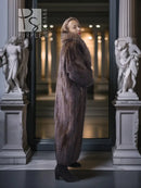 Mahogany-brown full-length mink coat with standing fur collar and long silhouette