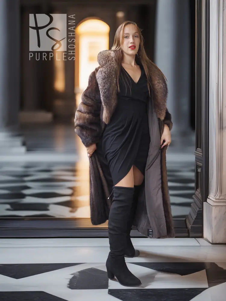 Full-length mink fur coat with fox-trim collar and open front over a black outfit