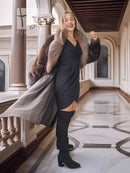 Mink fur coat front view with fox-trim collar; open drape revealing black outfit