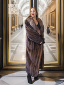 Full-length mink coat with dark brown textured fur, wrap-style front and wide collar