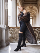 Side view of full-length mink fur coat with fox-trim collar and long, tapered sleeves
