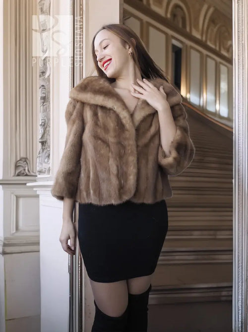 Vintage mink opera jacket with hood and tan fur, side profile with one sleeve visible.