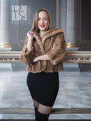 Tan mink fur opera jacket with hood, front view with hands crossed at chest