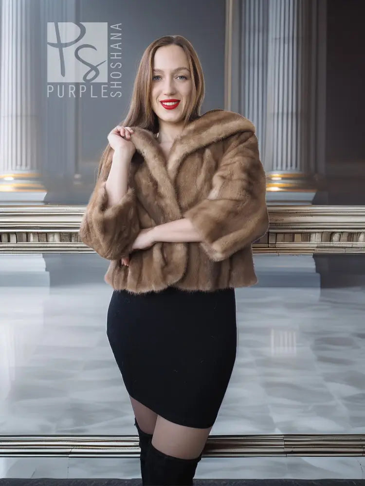 Tan mink fur opera jacket with hood, front view with hands crossed at chest