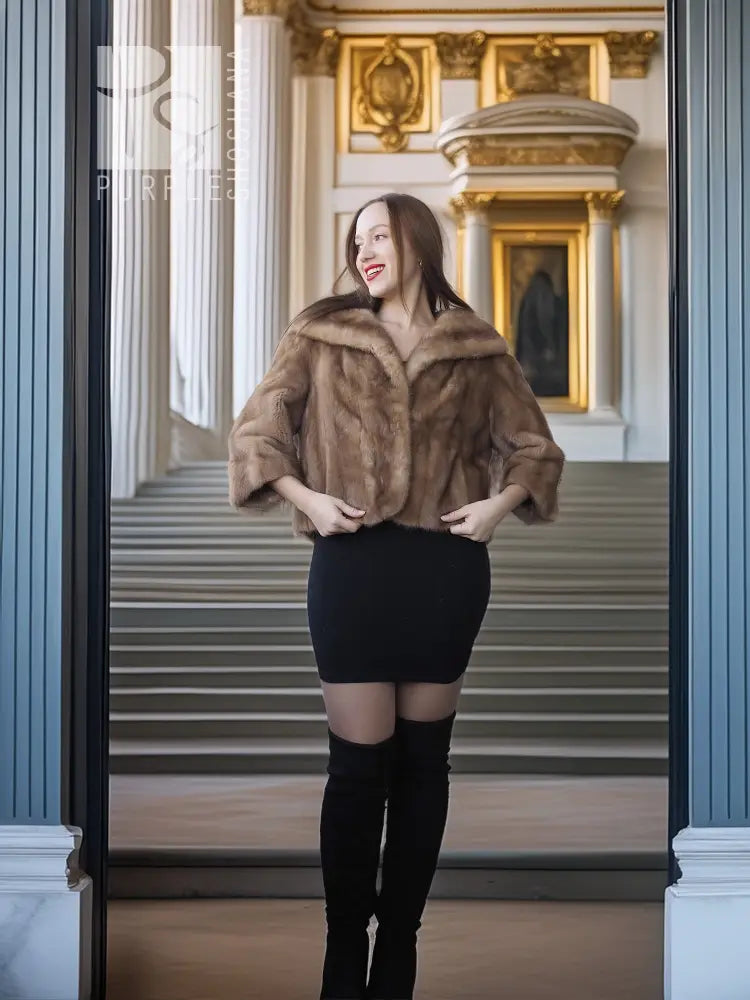 Tan mink fur opera jacket with hood, standing full-body view