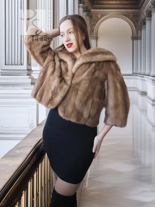 Tan mink fur opera jacket with hood, angled front view with raised collar