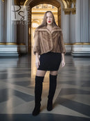 Vintage mink opera jacket with hood, tan fur, cropped silhouette over a black dress.