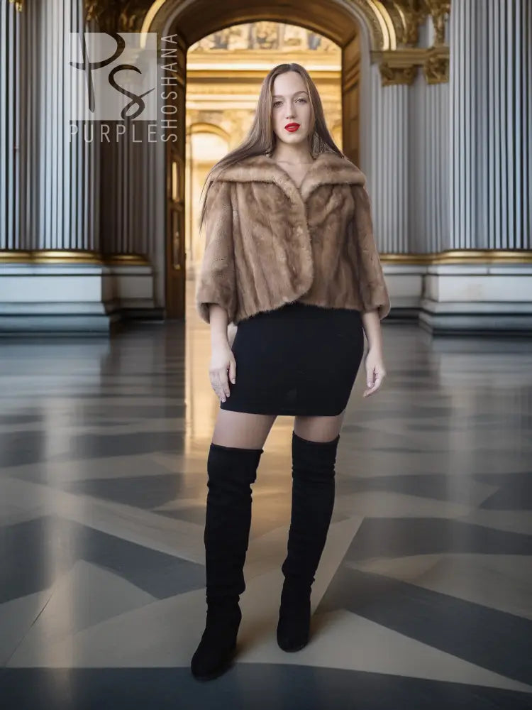 Vintage mink opera jacket with hood, tan fur, cropped silhouette over a black dress.
