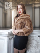 Vintage mink opera jacket with hood, tan fur shawl collar, worn with a black skirt.