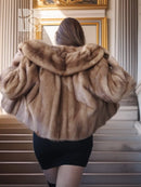 Back view of vintage mink opera jacket with hood, tan fur and voluminous shoulders.