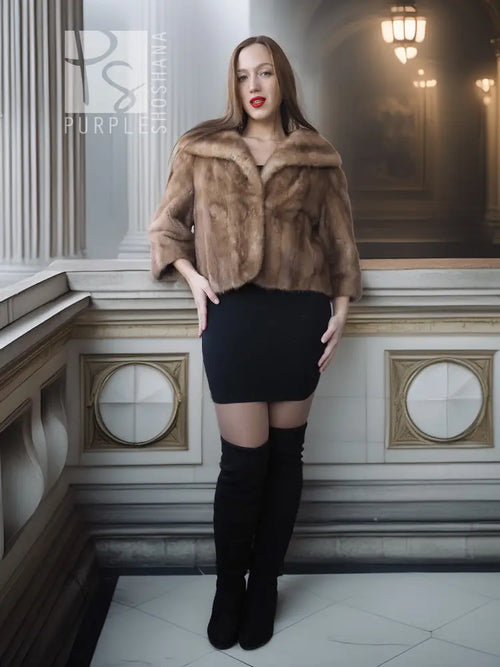 Vintage mink opera jacket with hood, tan fur, cropped fit over a black mini dress.