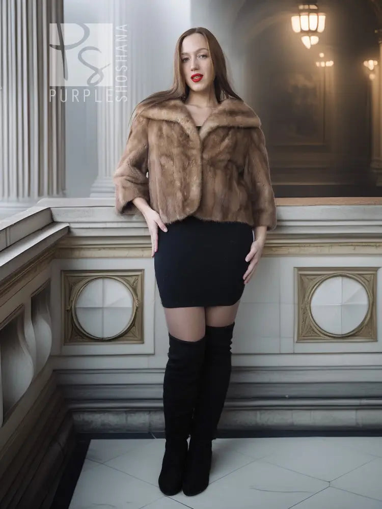Vintage mink opera jacket with hood, tan fur, cropped fit over a black mini dress.