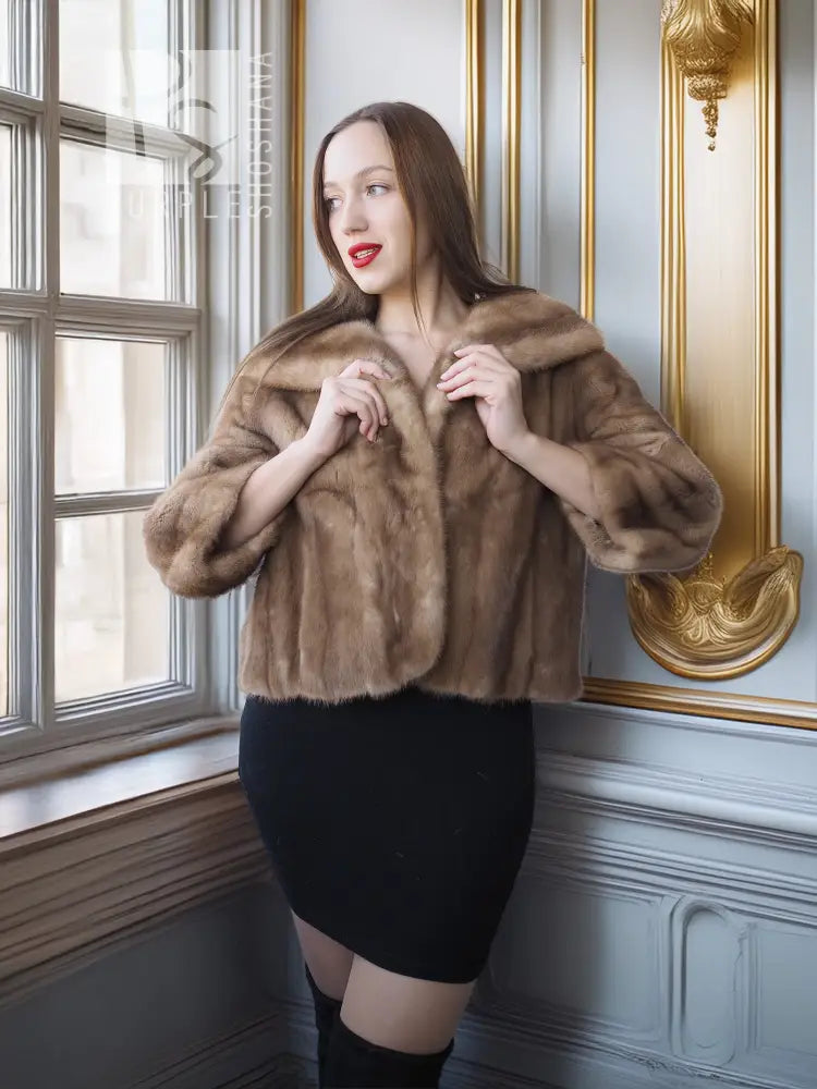 Vintage mink opera jacket with hood and tan fur, hands holding front lapels.