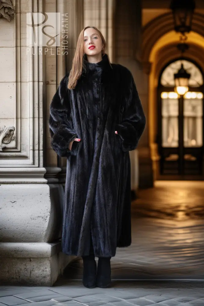 Full-length black mink fur coat with open front, long sleeves, and wide lapel.