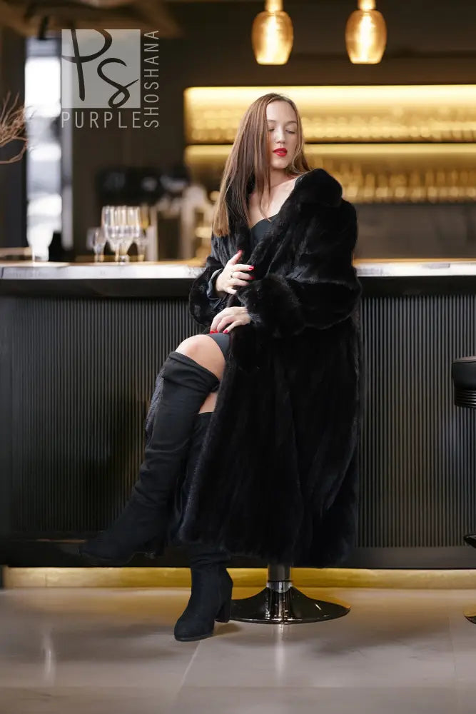 Black mink fur coat, full length, open front with plush collar and long sleeves.
