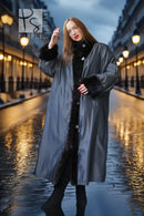 Black mink fur long coat with high collar, button front, and wide sleeves on rainy street.