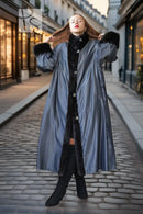 Black mink fur full-length coat with high collar and button closure, standing with arms raised.