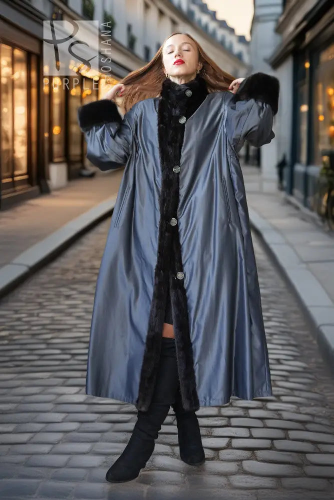 Black mink fur full-length coat with high collar and button closure, standing with arms raised.