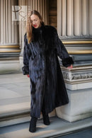 Long black mink fur coat draped at the sides, full-length with open front.