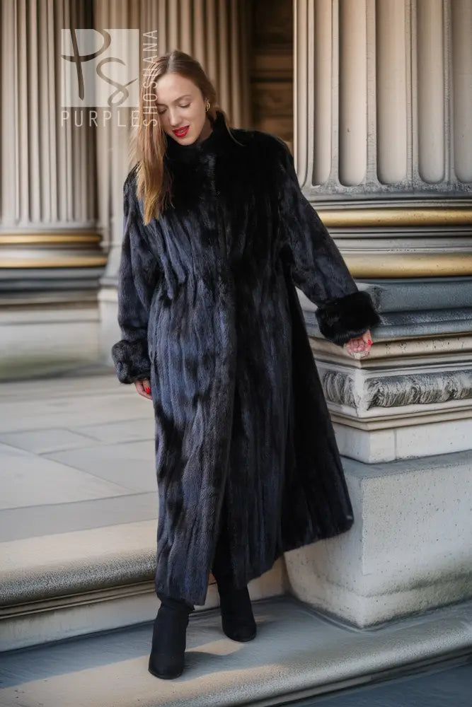 Long black mink fur coat draped at the sides, full-length with open front.