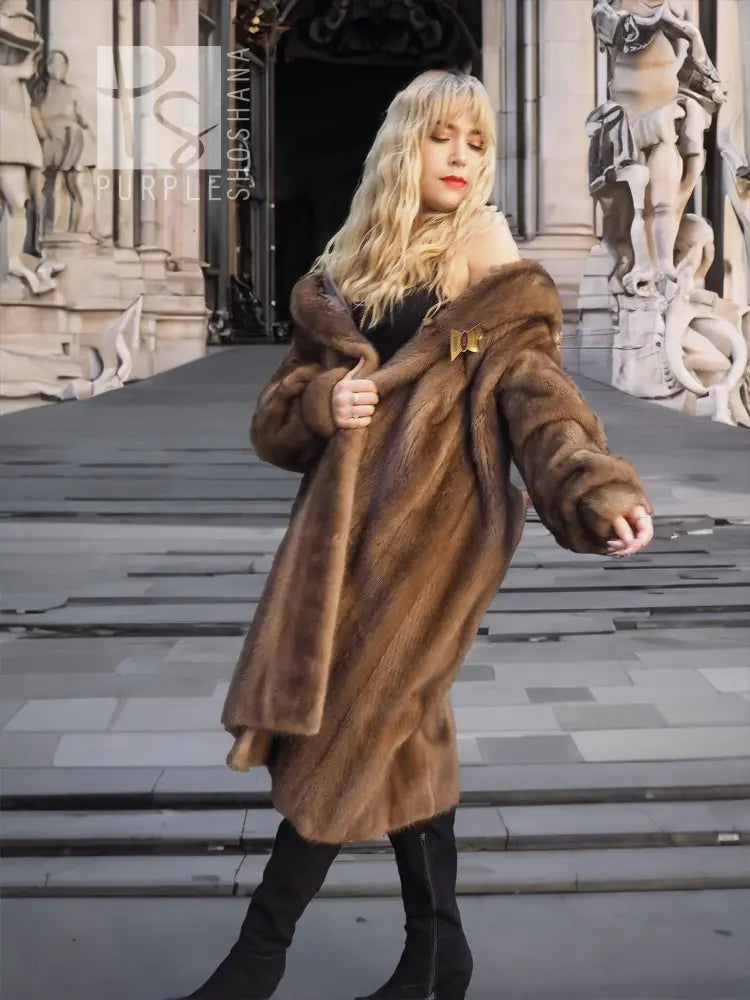 Women's brown mink fur coat with plush collar, walking pose, mid-length front.