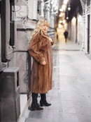 Brown mink fur coat with hood and straight front, mid-calf length.