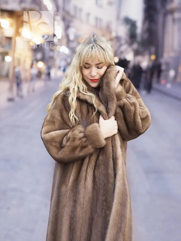 Women's brown mink fur coat close-up, plush collar and button-front placket visible.