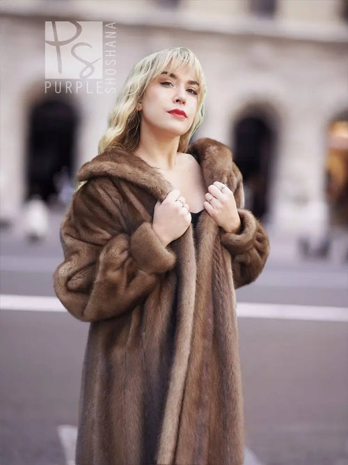 Women’s brown mink fur coat with hood, front close-up holding collar