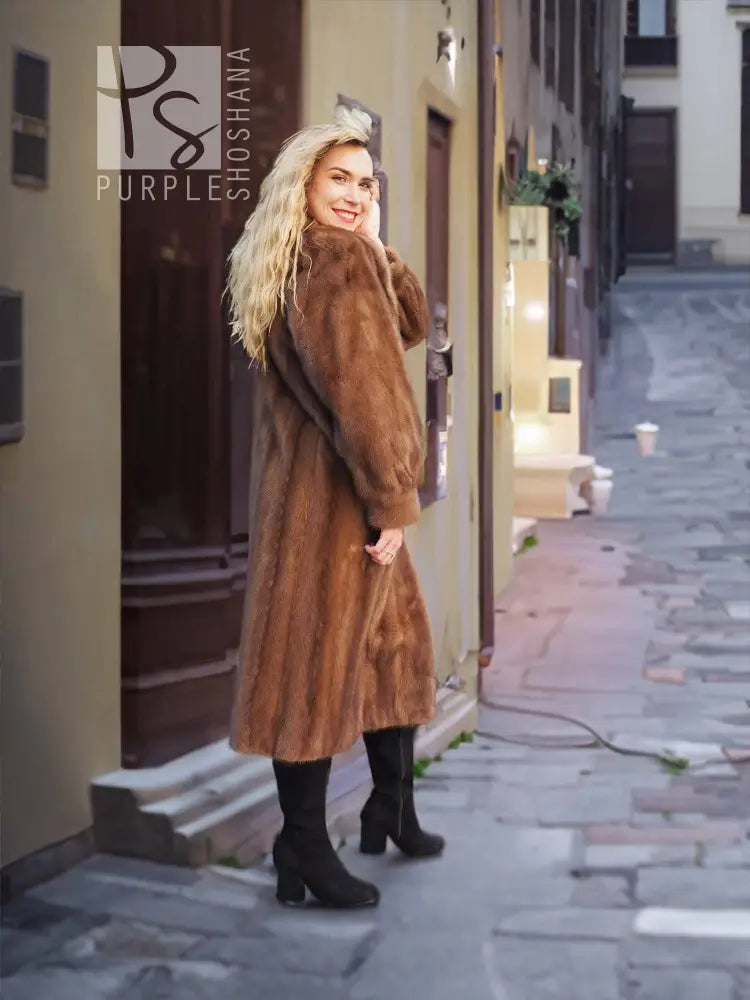 Brown mink fur coat with hooded neckline and relaxed longline cut.