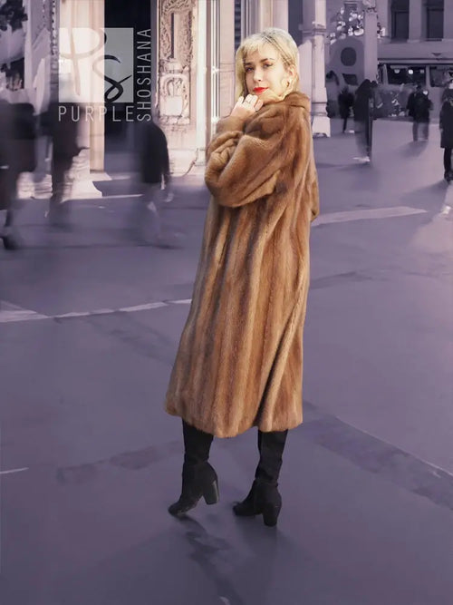 Brown mink fur coat with hood, long sleeves, belted waist and swing hem.