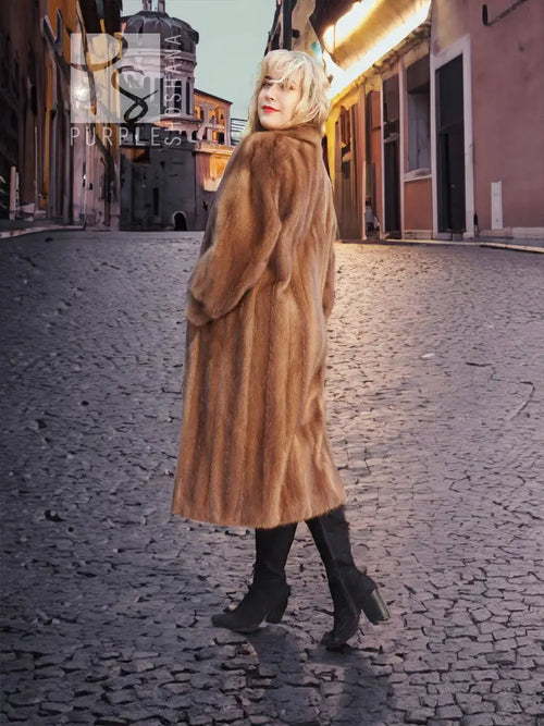 Long brown mink fur coat with hood and swing silhouette, street-style look.