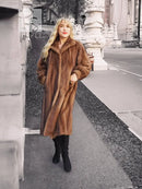Women's brown mink fur coat, long sleeves and plush collar, standing full-body view.