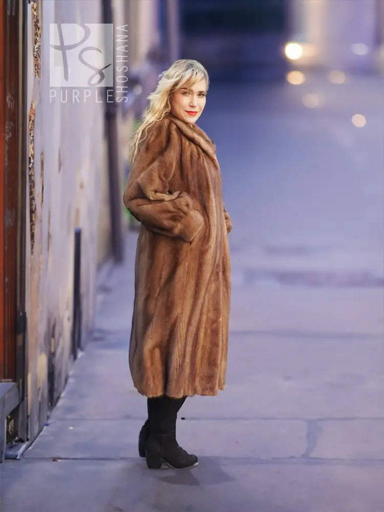 Women's brown mink fur coat, side profile walking view with plush collar.
