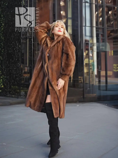 Long brown mink fur coat with hood and front pockets, A-line silhouette.