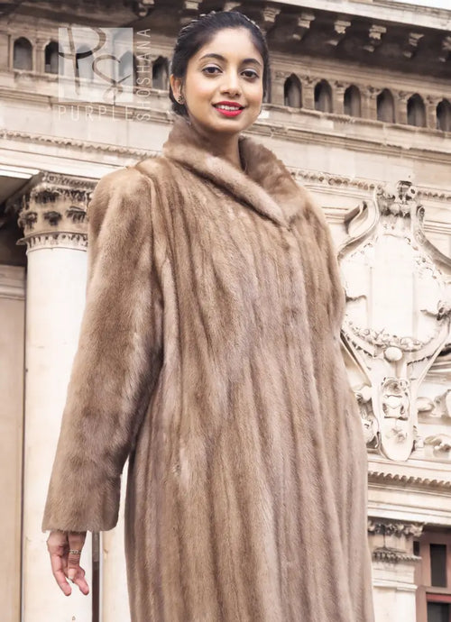 Light brown mink fur coat with hood and stand-up collar, side front view.