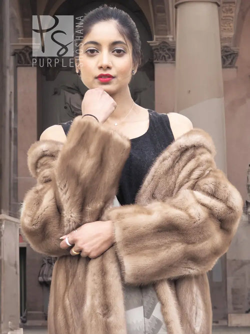 Light brown mink fur coat with hood, front view showing sleeve cuffs.