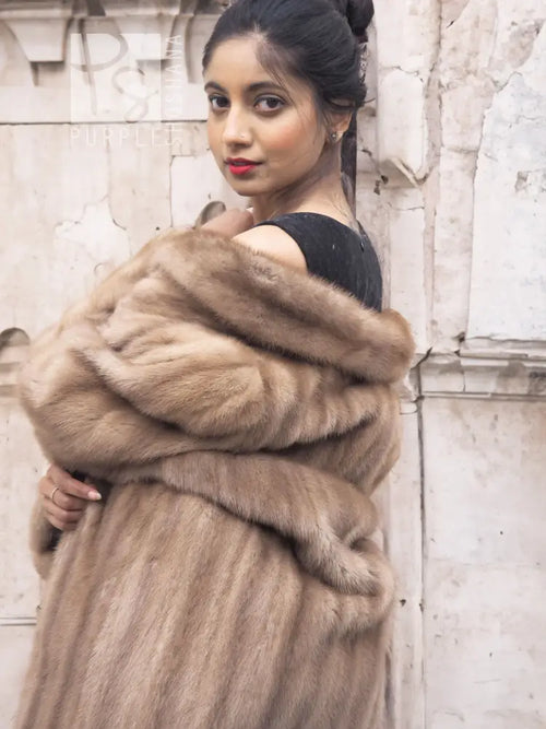 Light brown mink fur coat with thick fur collar and elbow-length sleeves, front close-up
