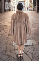 Light brown mink fur coat with hood, back view with full skirt length.