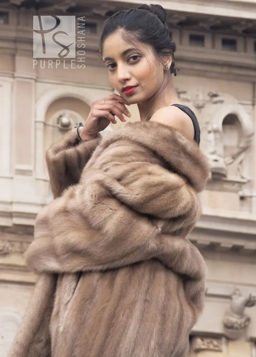 Light brown mink fur coat with hood, fur wrap detail at shoulder.