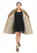 Light brown mink fur coat with quilted inner lining, open front and flared hem