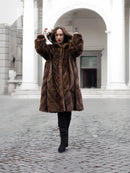 Brown mink fur swing coat with oversized hood, bell sleeves, front view
