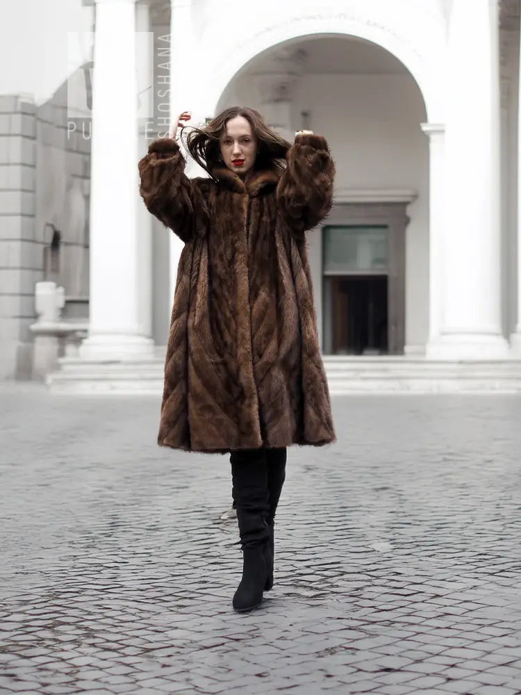 Brown mink fur swing coat with oversized hood, bell sleeves, front view